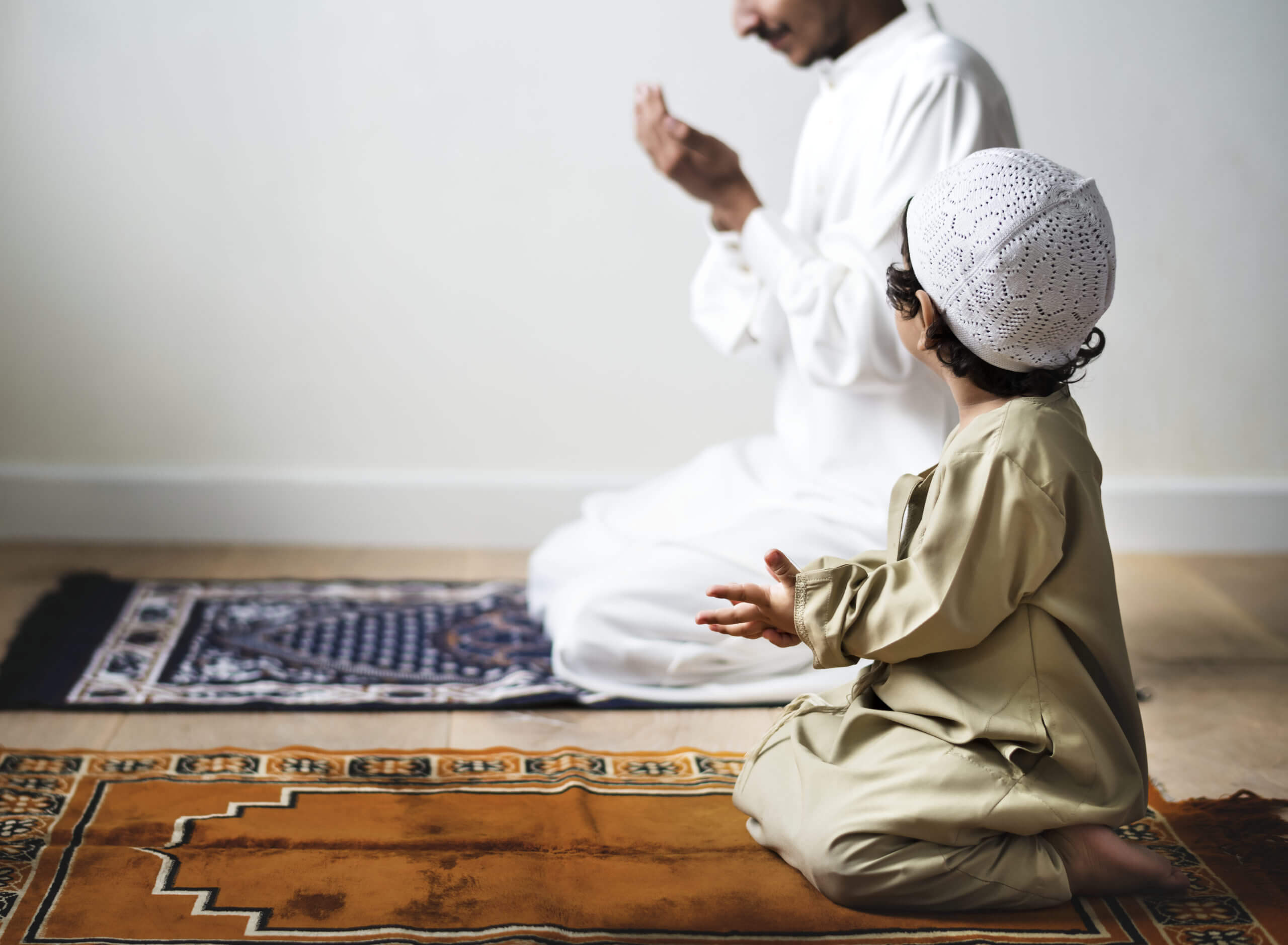 little-boy-praying-alongside-his-father-during-ram-2021-08-27-00-05-58-utc-scaled